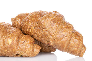 Group of three whole baked wholegrain croissant closeup isolated on white