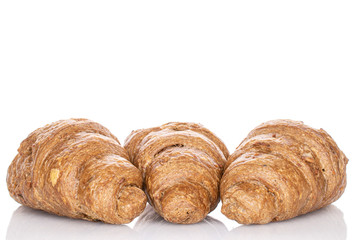 Group of three whole baked wholegrain croissant isolated on white
