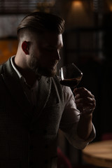 Professional sommelier man with a glass of red wine.