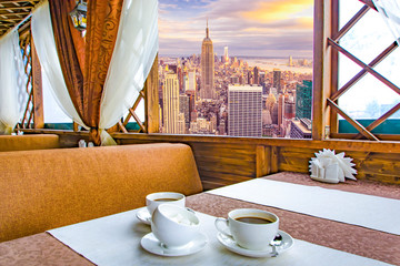 A Cup of coffee in a restaurant against the background of a beautiful landscape in the window .