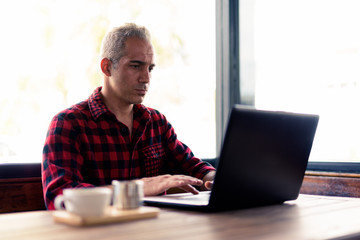 Handsome Persian man relaxing at the coffee shop