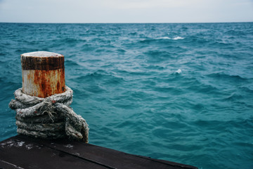 Mooring pins for boat. Close-up of a mooring rope with the sea background. 