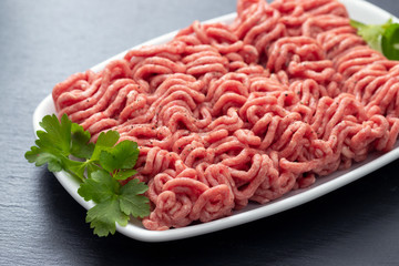 ground meat on white dish on ceramic background