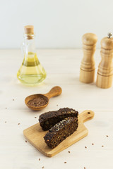 Slices of homemade linseed bread on a light wooden board. Healthy food, gluten free, sugar free, lactose free.