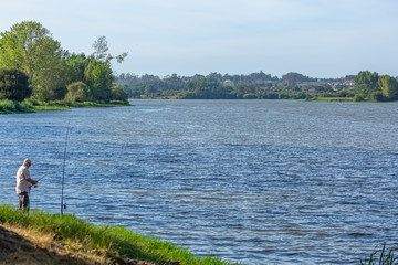 Fototapeta na wymiar View at the lake of Pateira Fermentelos, landscape around and a man fishing on