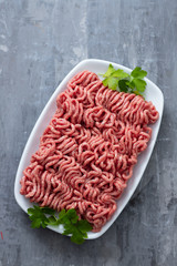 ground meat on white dish on ceramic background