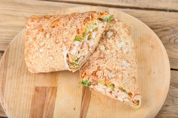 Shawarma Middle Eastern dish of pita bread, stuffed with grilled and then minced chicken meat with spices, sauces and pickled salad.