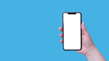 Modern smartphone with blank screen in female hand isolated on blue background mock up.