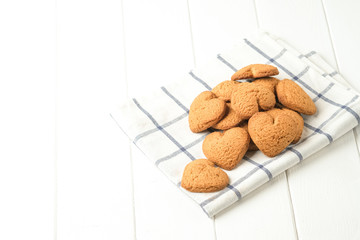 .Ginger cookie on a light napkin on a light background top view copy space.