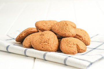 .Ginger cookie on a light napkin on a light background top view copy space.