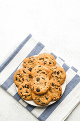 Cookies with chocolate on napkin on light background copy space.