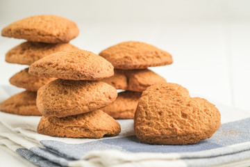 .Ginger cookie on a light napkin on a light background top view copy space.