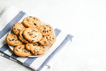 Cookies with chocolate on napkin on light background copy space.