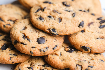 Cookies with chocolate on rustic background close-up.