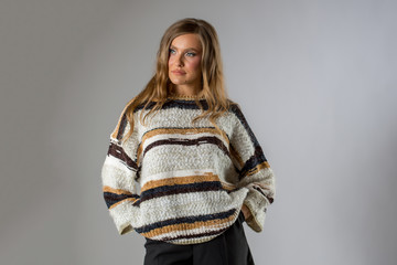 Beautiful girl posing in oversize sweater