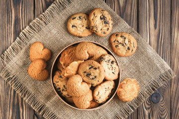 Mix of cookies in a wooden box on rustic background copy space.