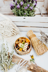 Vegetarian and vitamin-rich dish with tofu, beans and potatoes in eco-box, delivered by a delivery service, ordered online, decorated with bundles of straw on white wood, all in a Mediterranean style