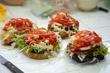 hamburger fast food  meal delicious American in the  restaurant,
burger  Decorated with onion cherry tomatoes, Close-up of homemade tasty burgers on wooden table, Craft beef burgers with vegetables
