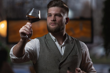 Professional sommelier man with a glass of red wine.