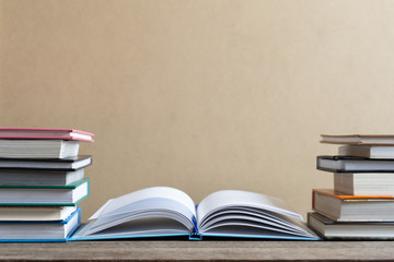 Books and textbook on wooden desk in library selective focus , Piles of books on reading desk in school with copy space for text.World book day and education concept.