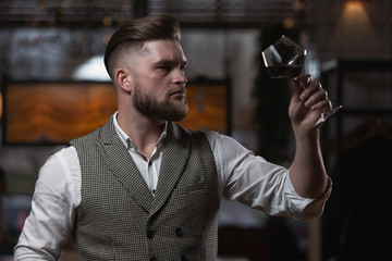 Fototapeta na wymiar Professional sommelier man with a glass of red wine.