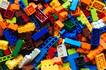 Colored toy bricks background. Lot of colorful rainbow toy bricks background.