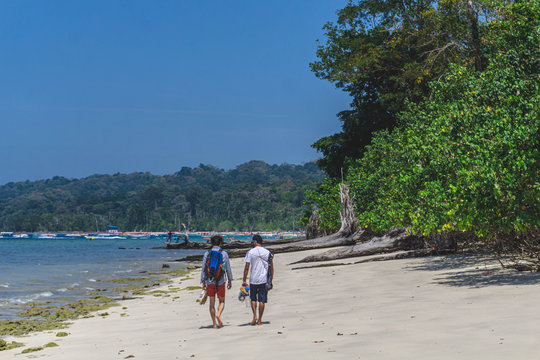 men walking by the beach in havelock andaman india