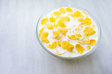 Pile in a bowl of milk of corn flakes white background