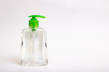 Transparent bottle with soap on gray background