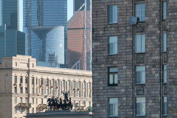 Old soviet residential houses, skyscrapers of Moscow city and triumphal arch. Moscow, Russia.