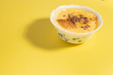 delicious custard in yellow and pink background