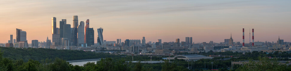 Fototapeta premium Sunset panorama of skyscrapers of Moscow city from Vorobyovy Gory viewpoint. Moscow, Russia.