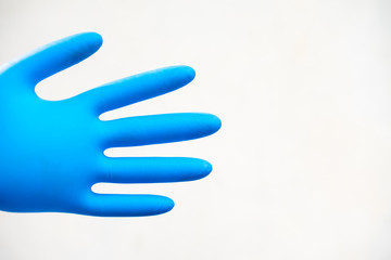 Obraz premium Close up hand in blue glove.