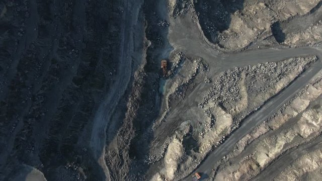 aerial view of asbestos quarry, silicate minerals mining. Dump truck in the asbestos quarry. drone flight above opencast mining quarry with lots of machinery at work, environment and ecology concept