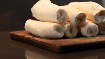 Edible manioc root (Manihot esculenta), peeled and frozen on neutral background