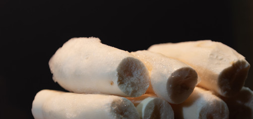 Edible manioc root (Manihot esculenta), peeled and frozen on neutral background