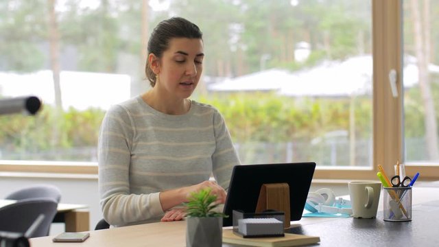 remote job, business and people concept - smiling young woman with tablet pc computer having online video conference working at home office