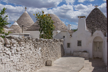 Fototapeta na wymiar The trulli of Alberobello is a traditional Apulian dry stone hut with a conical roof. Their style of construction is specific to the Itria Valley, in the Murge area of the Italian region of Apulia. 