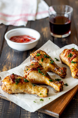 Chicken legs on a wooden background. Barbecue. Grill. American cuisine. Recipe. Rustic.