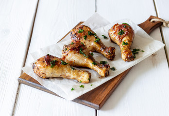 Chicken legs on a wooden background. Barbecue. Grill. American cuisine. Recipe. Rustic.