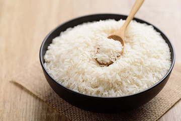 Organic Thai Jasmine rice grain with spoon in a bowl preparing for cooked

