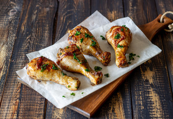 Chicken legs on a wooden background. Barbecue. Grill. American cuisine. Recipe. Rustic.