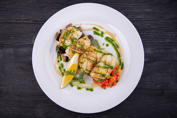 Grilled squid with stewed vegetables and greens