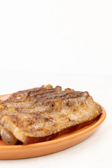 Stripes of grilled bacon on the plate with copy space above