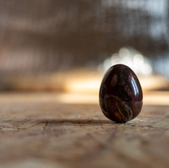 a marble maroon egg with an interesting texture