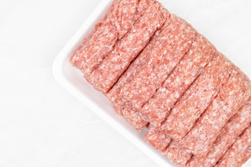 Top view of Raw kebabs on the white background