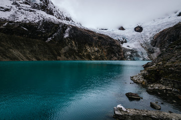 Arhuaycocha glacier lagoon in the surroundings of the base camp of the alpamayo mountain in the quebrada santa cruz in peru, horizontal