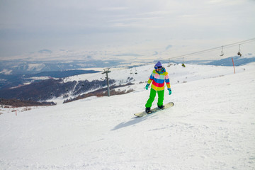 Girl snowboarding on the ski slope in Tsakhkadzor (Tsaghkadzor), Kotayk Province, Armenia