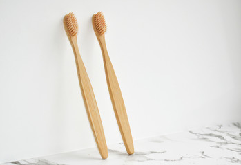 Eco-friendly bamboo toothbrush made.  light gray marble surface, white background. Biodegradable personal care products. No plastic concept. Zero waste.