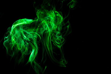 Fototapeta premium Green smoke on black background